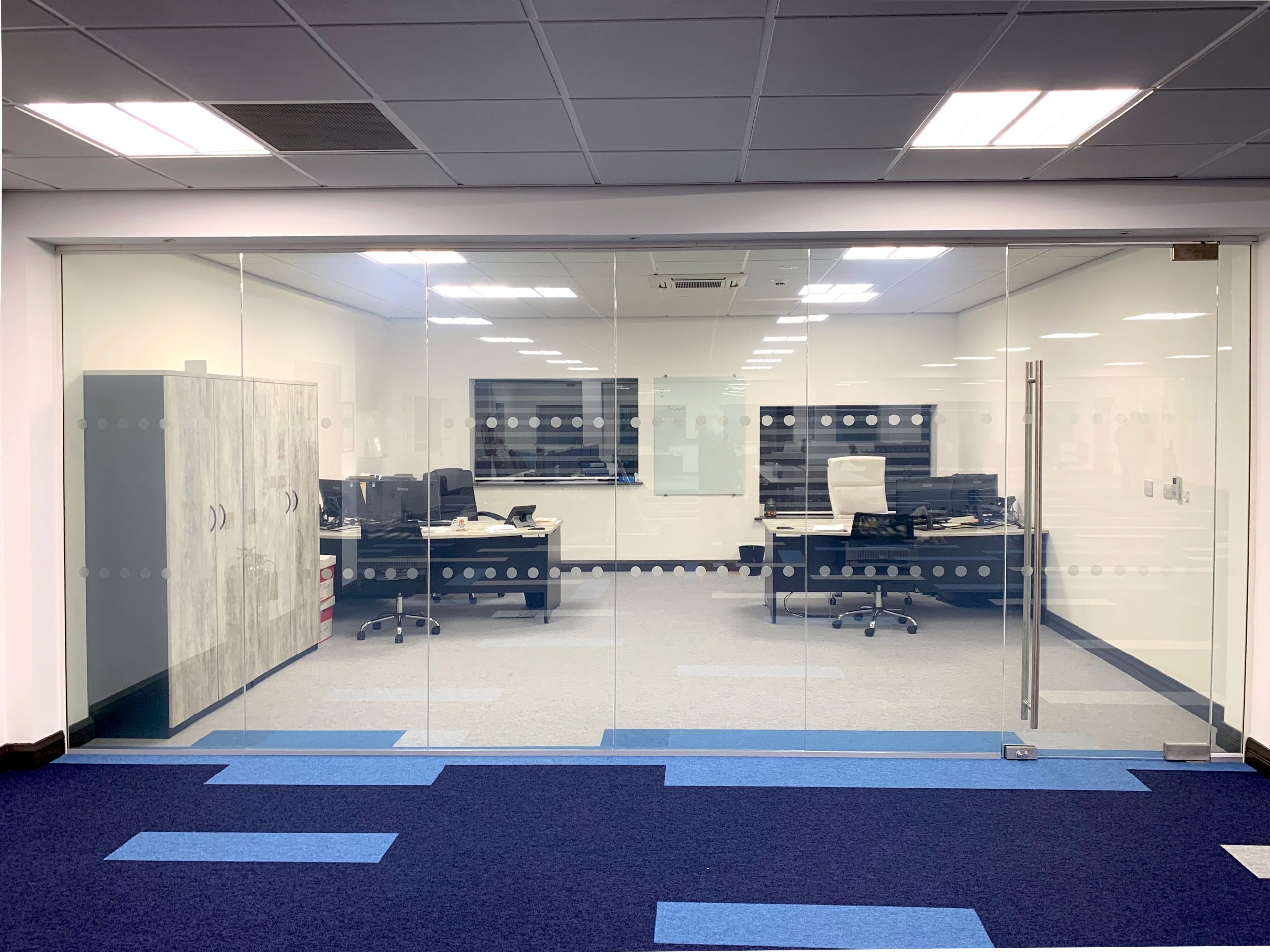 Clear glass partition installed in a modern office, switched on and transparent